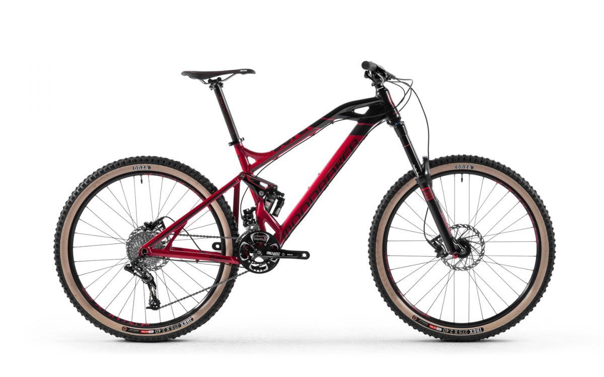 Mondraker Dune: A red and black mountain bike with wide tires, a full suspension frame, and disc brakes, positioned against a plain white background.