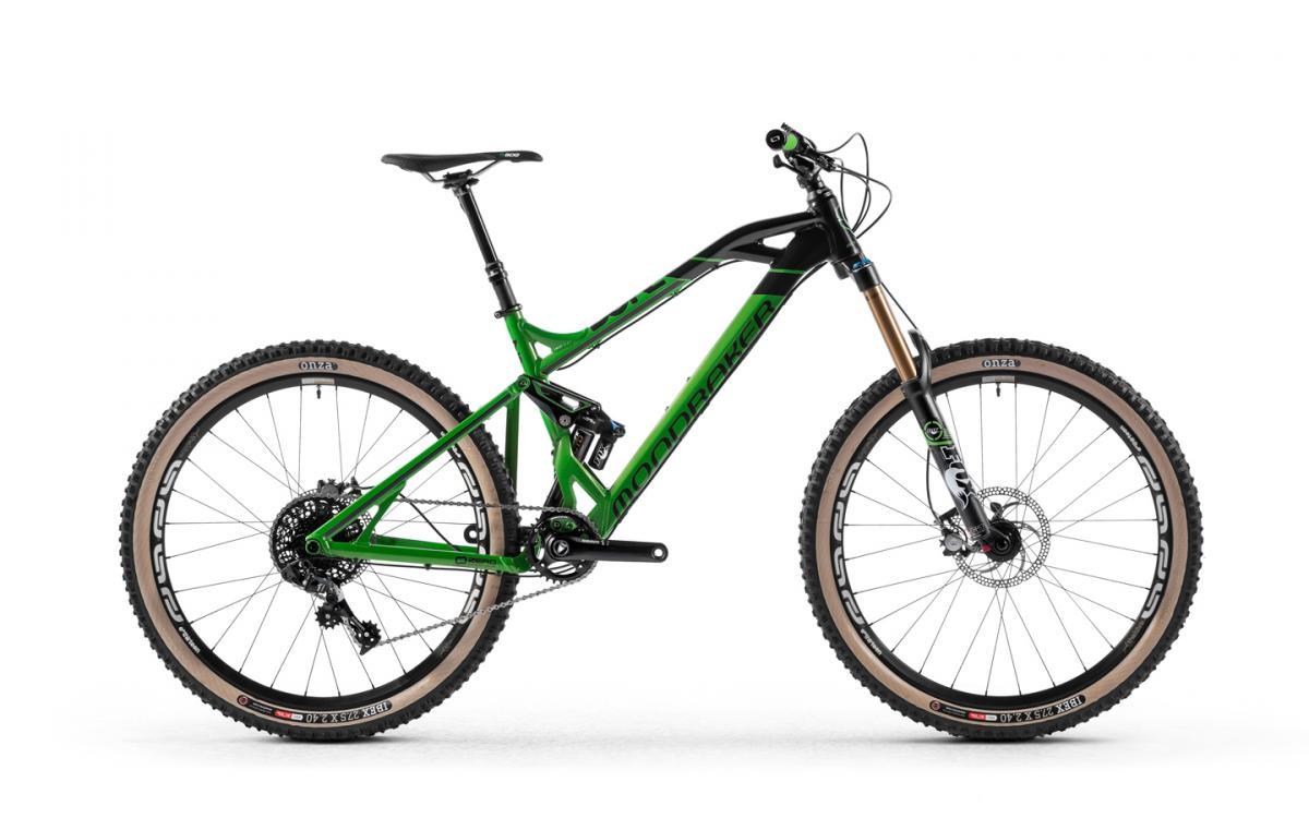 Mondraker Dune XR: A green and black mountain bike standing upright on a white background. The bike features thick tires with a distinctive design, a front suspension fork, and a sleek frame, showcasing a modern and sporty aesthetic.