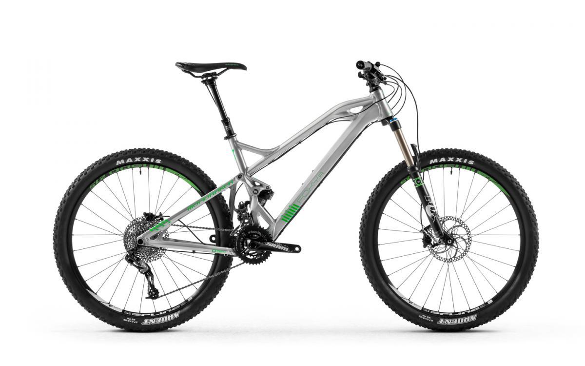 Mondraker Foxy R: A modern mountain bike with a lightweight aluminum frame, featuring large knobby tires for traction, front suspension forks, and a sleek design. The bike has a silver finish with green accents and is presented against a white background.