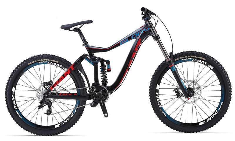Giant Glory 2: A modern, high-performance downhill mountain bike featuring a sleek black and red frame, large knobby tires, and a rear suspension system for enhanced stability and control on rough terrain.