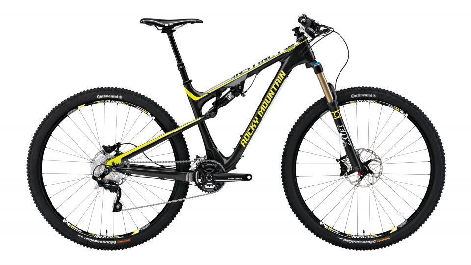 Rocky Mountain Instinct 970 MSL: Alt text: A black and yellow mountain bike with a lightweight frame, featuring front suspension and wide tires, positioned against a white background.