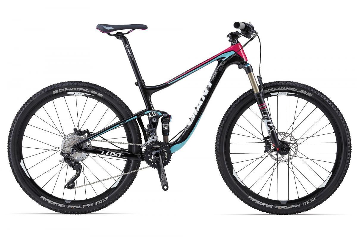 Giant Lust Advanced 2: Mountain bike featuring a black and teal frame with pink accents, equipped with front suspension and knobby tires suitable for off-road terrain. The bike has a modern, lightweight design and includes high-quality components for performance on trails.