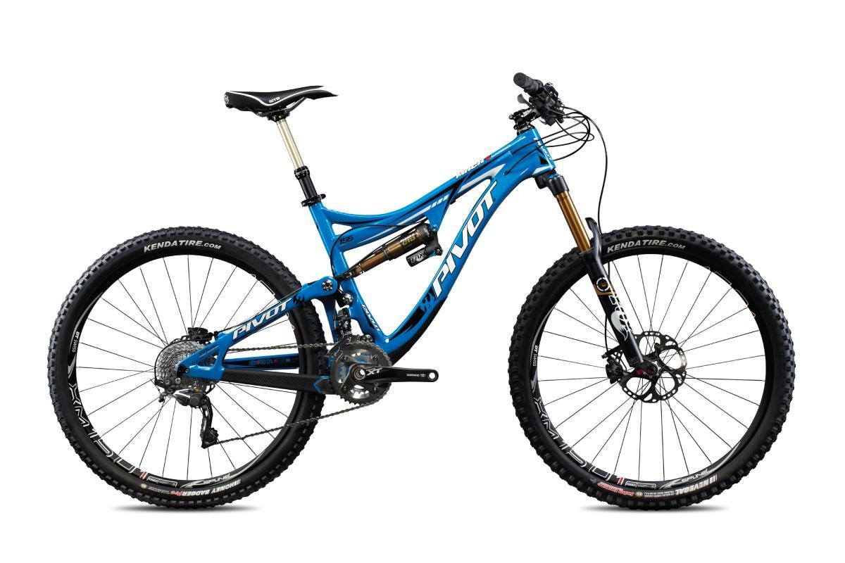 Pivot Mach 6 Carbon: A blue mountain bike with a full suspension system, featuring a sleek frame design and high-quality components. The bike is shown from the side, highlighting its large tires, disc brakes, and prominent branding on the frame.