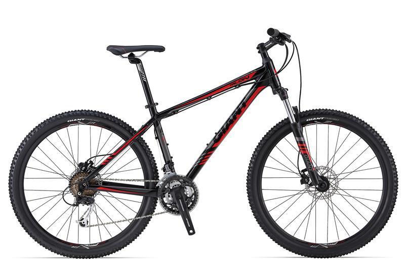 Giant Talon 27.5 4: A black and red mountain bike with a sturdy frame, featuring thick tires designed for off-road use. The bike includes a standard seat, front suspension, and multiple gears, showcasing its capability for rugged terrain and outdoor adventures.
