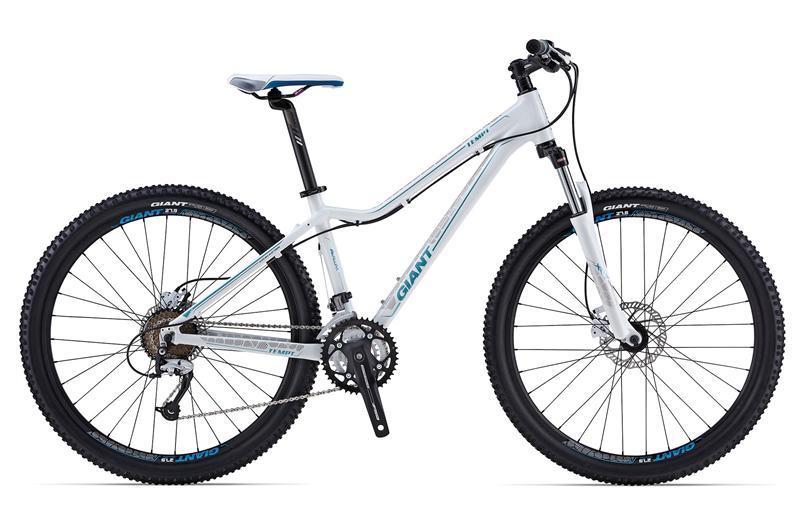 Giant Tempt 4: A modern mountain bike featuring a lightweight white frame with blue accents, front suspension, wide tires, and a standard gear setup, positioned on a plain white background.