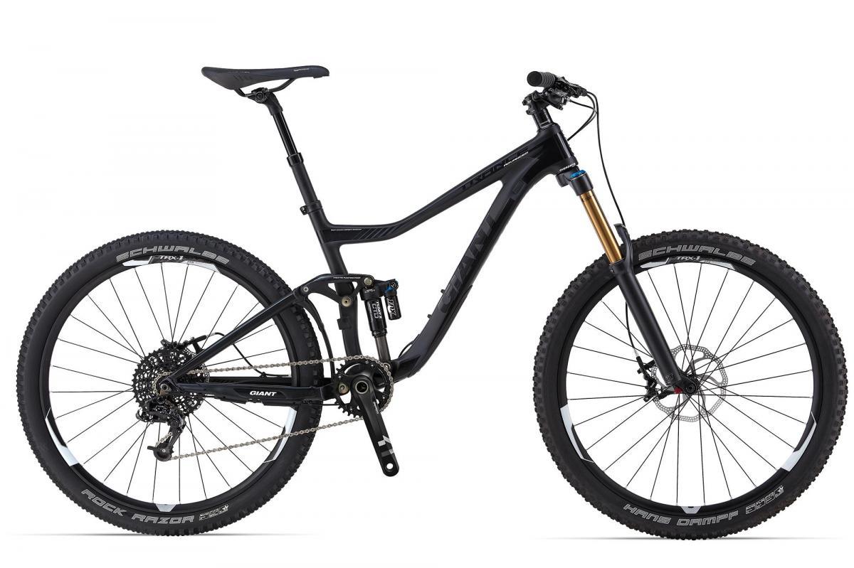 Giant Trance Advanced SX 27.5: Black mountain bike with a sleek design, featuring wide tires, a dual suspension system, and a prominent front fork. The bike has a modern frame geometry and is equipped with high-quality components suitable for off-road terrain.