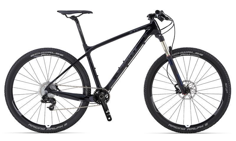 Giant XtC Advanced 27.5 1: A modern mountain bike with a sleek black frame, front suspension fork, and knobby tires. The bike features a lightweight construction, a prominent gear system, and disc brakes, making it suitable for off-road cycling. The wheels are equipped with racing tires designed for traction and speed.