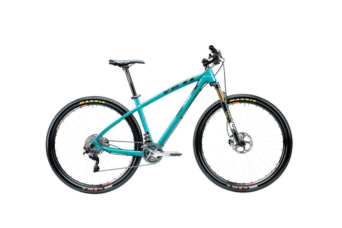 Yeti ARC C: A turquoise mountain bike with a lightweight frame, equipped with disc brakes and knobby tires. The bike features a front suspension fork and is positioned on a white background.