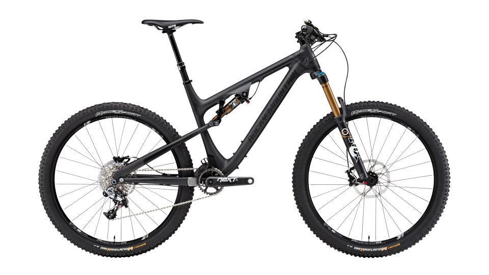 Rocky Mountain Altitude: A modern mountain bike featuring a lightweight carbon frame, dual suspension, and wide tires designed for off-road terrain. The bike has a sleek black finish with gold accents on the front suspension fork and is equipped with high-performance components for optimal handling and control.