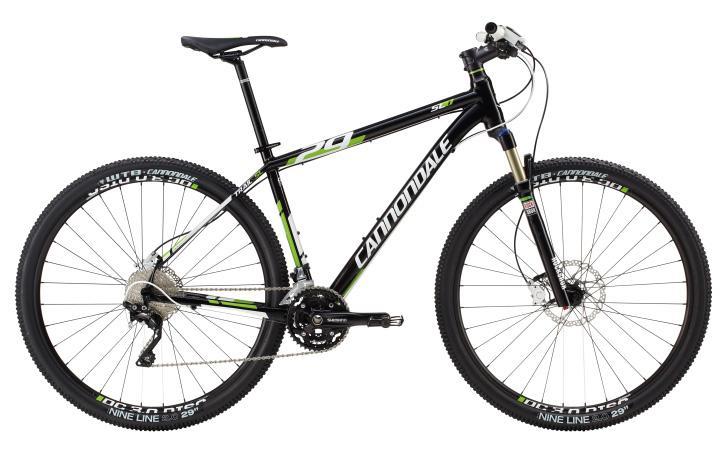 Cannondale Trail SL 29 1: Alt text: A black Cannondale mountain bike with green accents. The bike features a lightweight frame, wide tires with knobby tread, and is equipped with front suspension, making it suitable for off-road cycling.