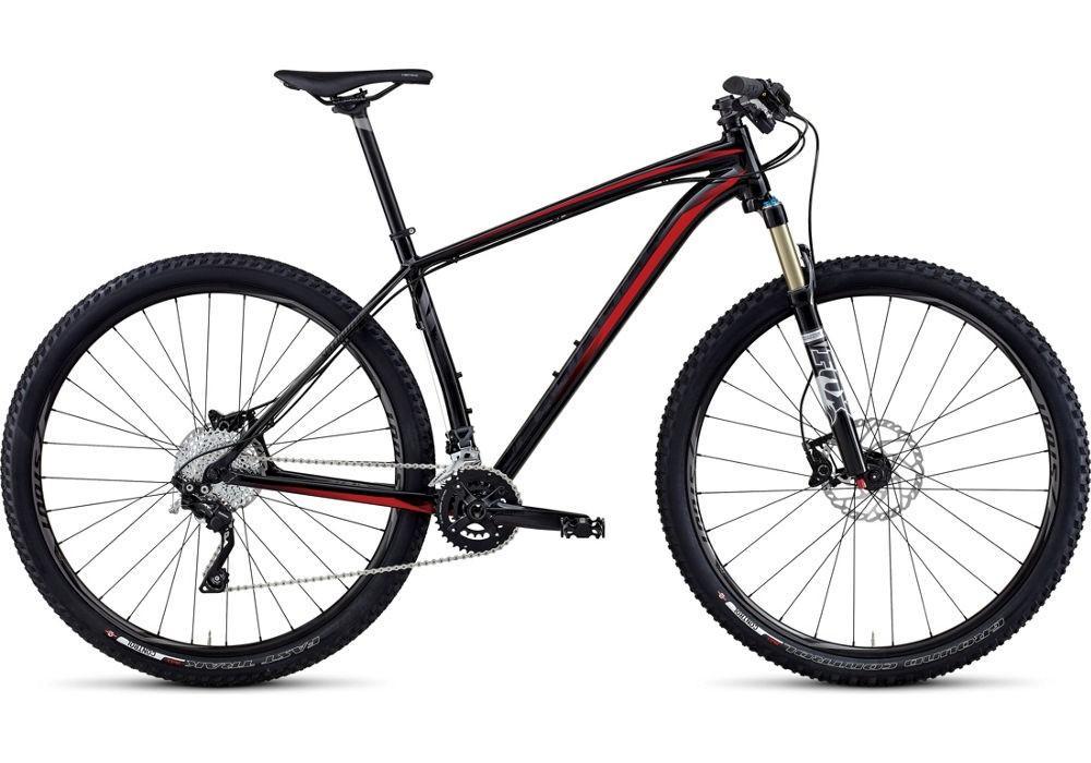 Specialized Crave Pro 29: A modern mountain bike featuring a sleek black and red frame, front suspension fork, and robust tires designed for off-road terrain. The bike has a dual chainring setup and disc brakes for enhanced performance and control.