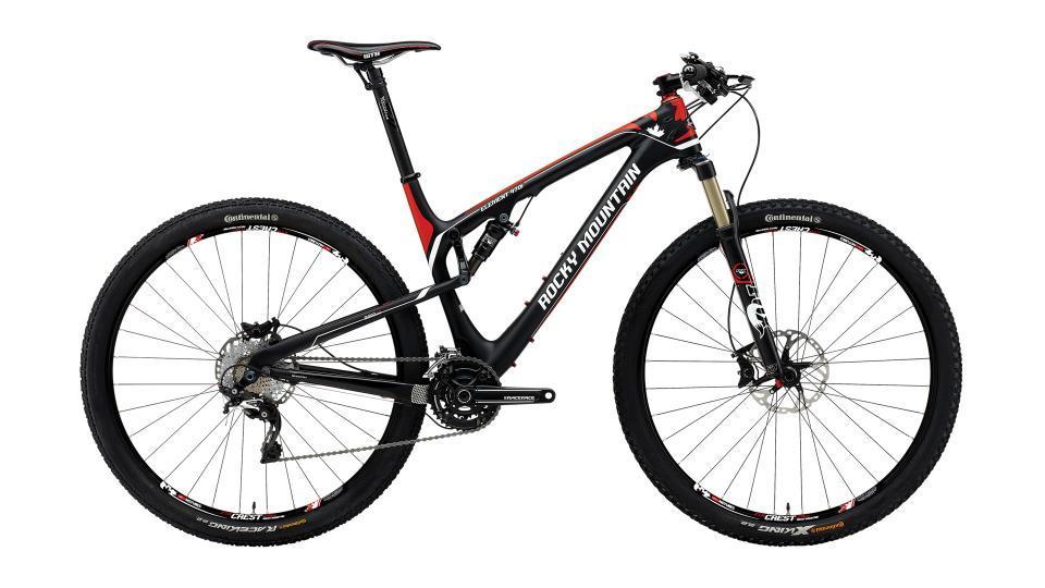 Rocky Mountain Element 970 RSL: A high-performance mountain bike featuring a sleek black and red design, lightweight carbon frame, and front suspension. The bike is equipped with disc brakes and rugged tires suitable for off-road terrain.