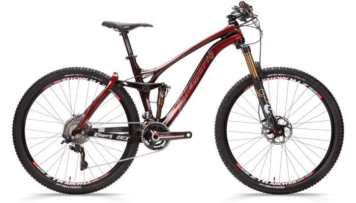 Ellsworth Absolute Truth: A sleek mountain bike with a glossy black and red frame, featuring wide tires, a dual suspension system, and a prominent front fork. The bike is equipped with disc brakes and is positioned on a plain white background, showcasing its design and components.