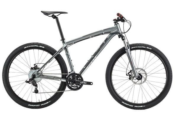 Felt 7 Eighty: A silver mountain bike with wide tires and a lightweight frame, featuring a front suspension fork, gear shifters, and disc brakes. The bike is positioned on a white background, showcasing its sleek design and components.