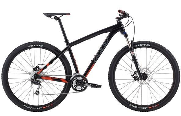 Felt Nine 60: Black and orange mountain bike with a lightweight frame, featuring front suspension, disc brakes, and wide tires designed for off-road use. The bike
