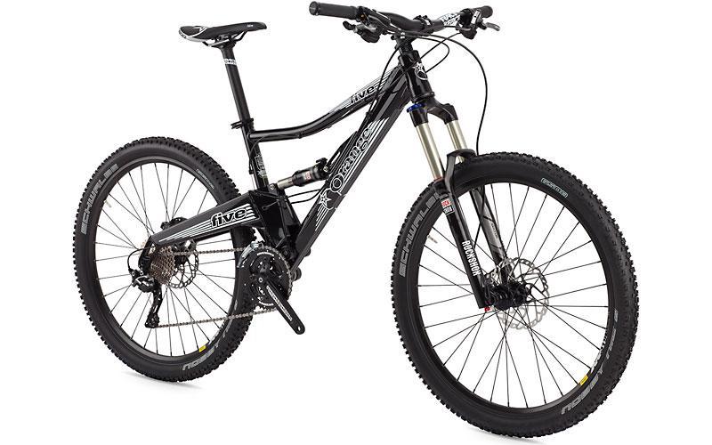 Orange Five S: A black mountain bike featuring a sturdy frame, front suspension forks, and wide tires designed for off-road terrain. The bike has a modern design with multiple gears and disc brakes, suitable for both recreational and adventurous riding.