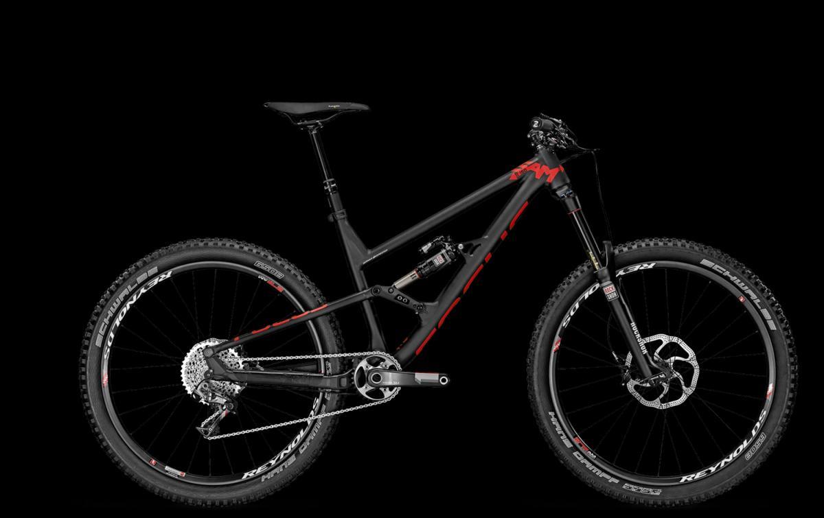 Focus Sam 1.0: A modern black mountain bike with red accents, showcasing a sturdy frame, thick tires, and front suspension. The bike is positioned against a black background, highlighting its design and features.