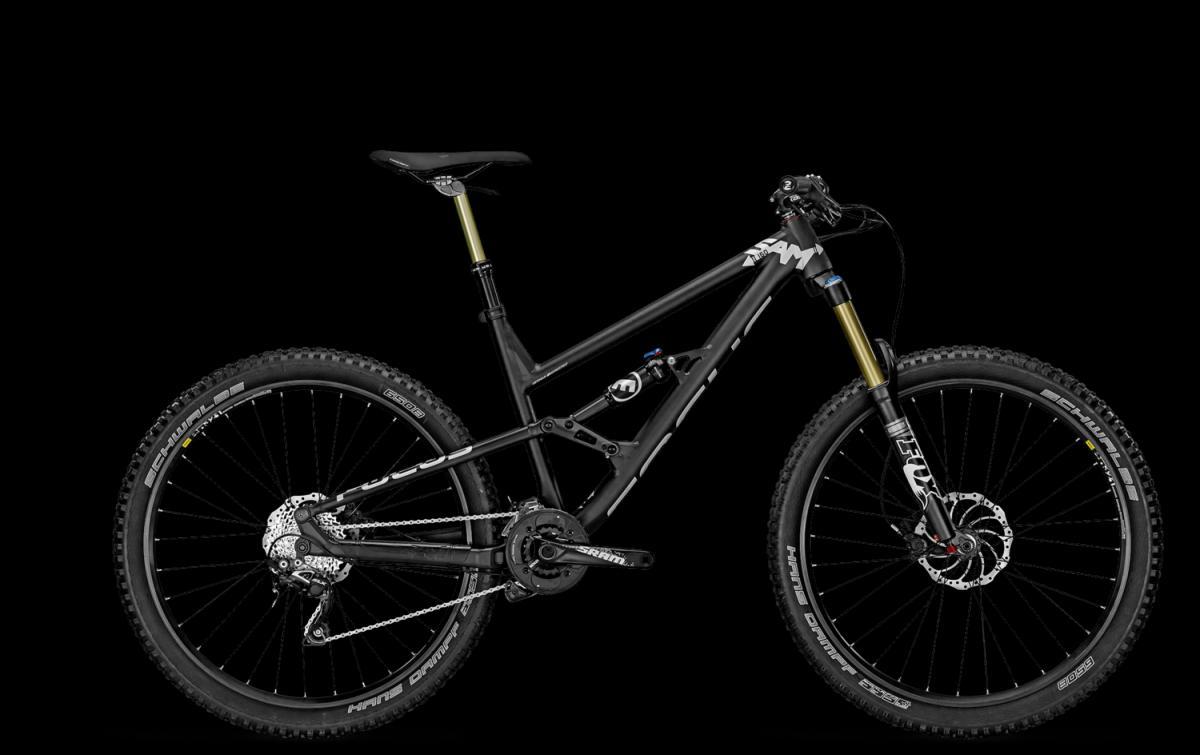 Focus Sam 3.0: Mountain bike featuring a sleek black frame and prominent suspension components, set against a solid black background. The bike is equipped with durable tires designed for off-road use and has a professional look, showcasing advanced features such as a high-performance drivetrain and suspension system.