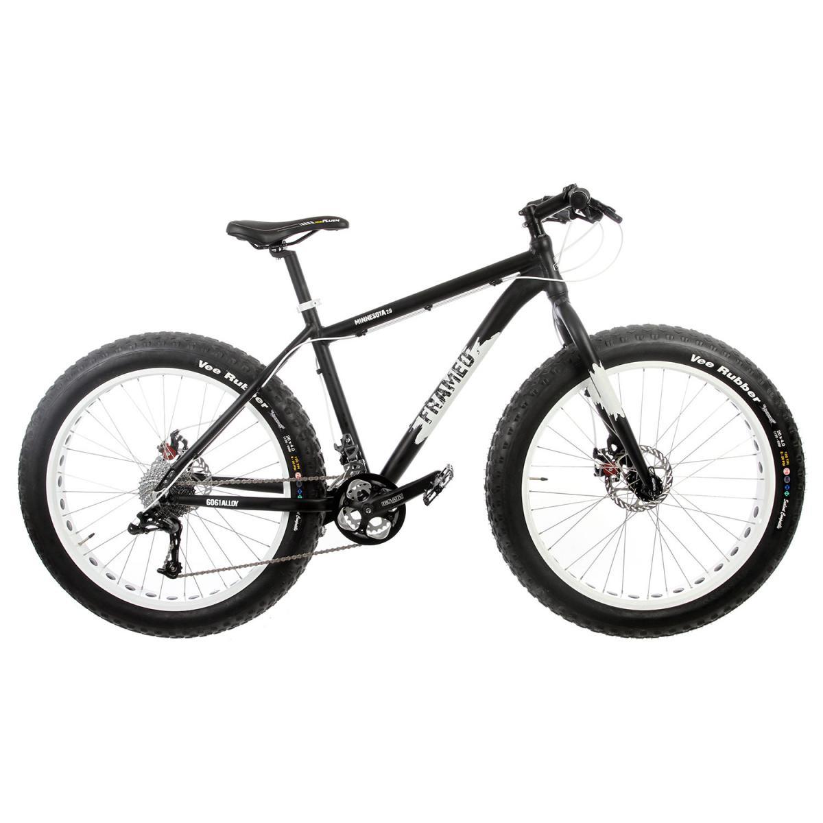 Framed Minnesota 2.0: Alt text: A black and white fat bike with large tires, featuring a sturdy frame, disc brakes, and a modern design. The bike is positioned against a plain background, showcasing its features and specifications.