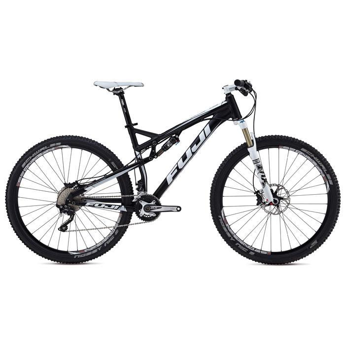 Fuji Outland 29 1.1 D: A black and white mountain bike with dual suspension, featuring large tires, disc brakes, and a sleek frame design. The bike is displayed on a white background, emphasizing its modern design and branding.