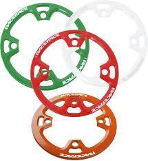 Race Face Lightweight Bash: Four colorful bicycle chainrings in green, white, red, and orange, featuring cut-out designs for weight reduction.