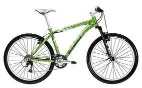 Trek Marlin: A green mountain bike with a lightweight frame, front suspension, and rugged tires, positioned on a white background.