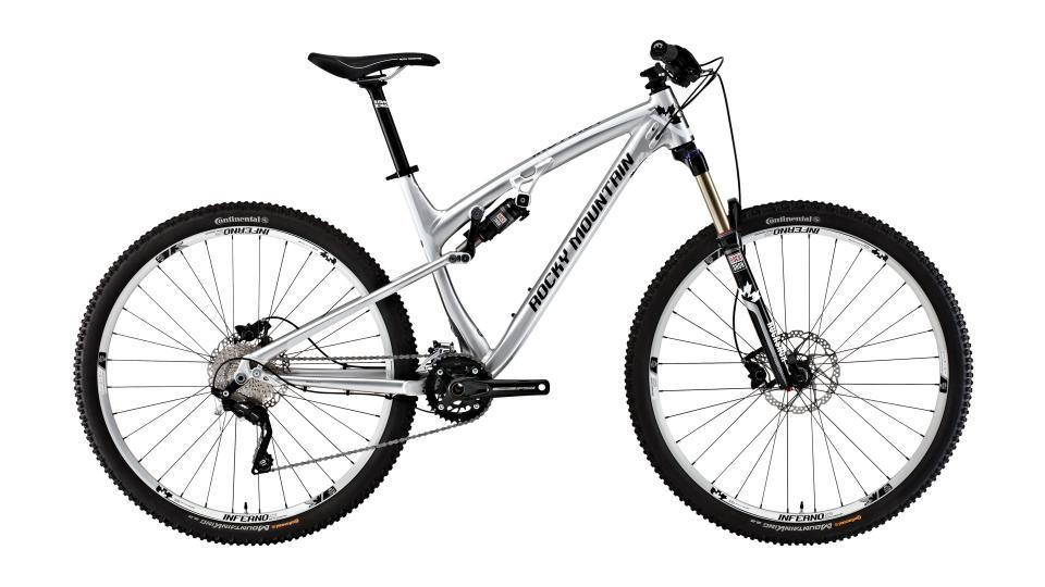 Rocky Mountain Instinct 930: A silver Rocky Mountain mountain bike with a sleek aluminum frame, front suspension, and knobby tires. The bike features a standard handlebar and a single gear shifter. It is positioned against a plain background, showcasing its design and components.