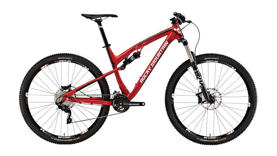 Rocky Mountain Instinct 950: Mountain bike with a red frame, featuring a suspension fork, wide tires, and disc brakes. The brand name "Rocky Mountain" is prominently displayed on the frame.