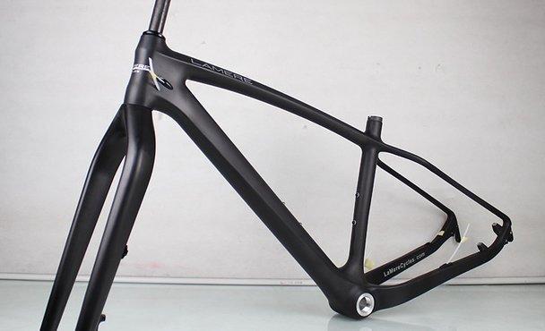 Lamere Carbon Fat Bike: A sleek, black bicycle frame displayed on a light background, showcasing its modern design and lightweight construction. The frame features a minimalist style with smooth lines and no visible components attached.