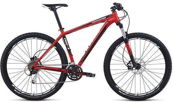 Specialized Rockhopper: A red mountain bike with a lightweight frame, featuring thick tires and disc brakes. The bike has a sleek design, with a prominent rear suspension and multiple gears for off-road riding. The handlebars are straight, and the seat is positioned for an aggressive riding stance.