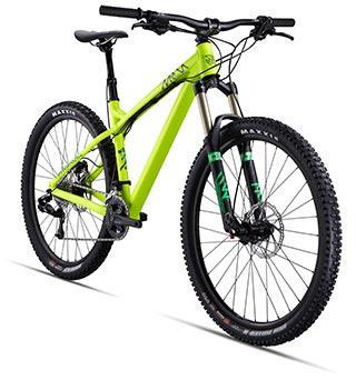 Commencal Meta HT 2: A vibrant green mountain bike with front suspension, wide tires, and disc brakes, positioned at an angle to showcase its sleek design and features.