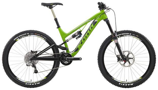 Kona Process 153 DL: A bright green full-suspension mountain bike with black accents, featuring wide tires and a modern design. The bike is positioned at an angle, showcasing its frame, handlebars, and components. Ideal for off-road cycling and outdoor adventures.
