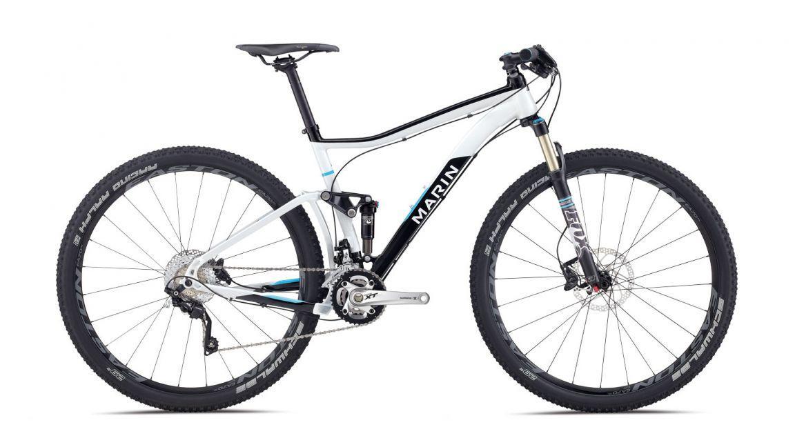 Marin Rift Zone 29er XC8: Alt tag: A white and black mountain bike with blue accents, featuring a lightweight frame, front suspension, and disc brakes, positioned against a plain background.