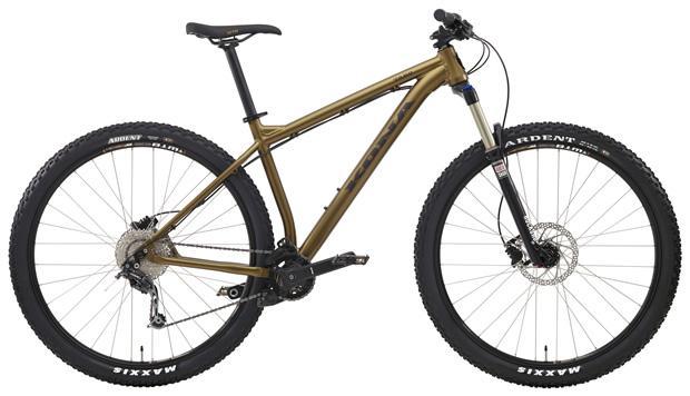 Kona Taro: Mountain bike with a sleek brown aluminum frame, front suspension, and wide tires designed for off-road riding. The bike features disc brakes and has a streamlined design for improved performance.