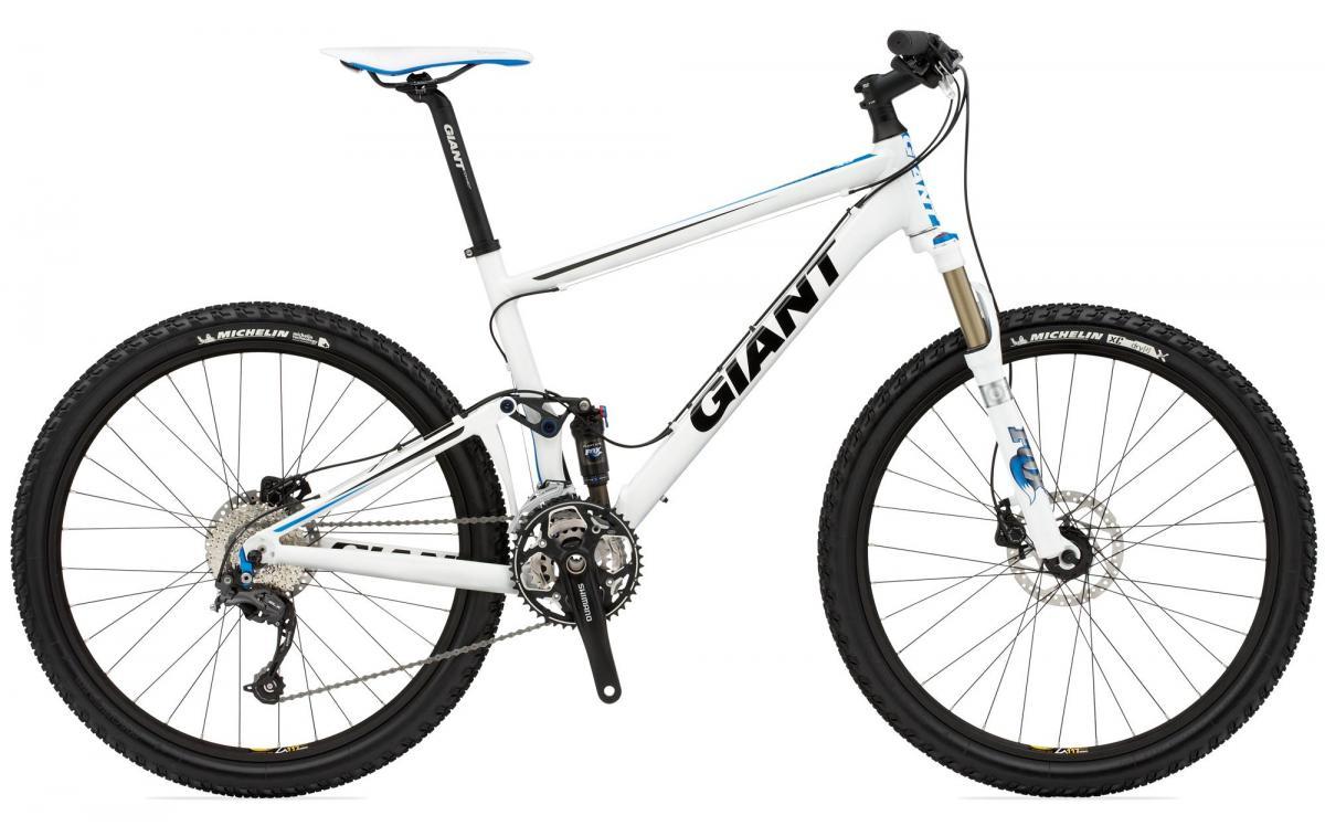 Giant Anthem: Alt text: A white mountain bike with blue accents, featuring a Shimano drivetrain, Michelin tires, and a suspension fork. The bike is positioned at an angle to showcase its frame and components.
