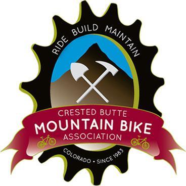 Logo of the Crested Butte Mountain Bike Association, featuring a stylized mountain with two crossed tools, outlined with a gear shape, and a banner that reads "Mountain Bike Association" along with "Colorado - since 1983."