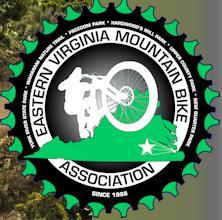 Logo of the Eastern Virginia Mountain Bike Association, featuring a silhouette of a mountain biker in action, set against a green outline of Virginia. The logo includes text around the edge that reads "EASTERN VIRGINIA MOUNTAIN BIKE ASSOCIATION" and "SINCE 1988," with a star accent at the bottom. The design is framed with a gear-like shape in black and green.