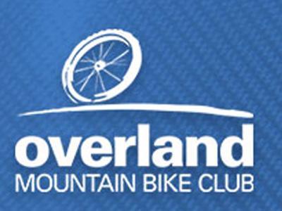 Logo of the Overland Mountain Bike Club featuring a stylized bicycle wheel and the text "overland MOUNTAIN BIKE CLUB" on a blue background.