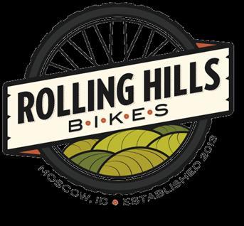 Logo for Rolling Hills Bikes, featuring a bicycle wheel design, with the text "Rolling Hills Bikes" prominently displayed. Below the name, it includes "Moscow, ID" and "Established 2013," accompanied by a stylized illustration of rolling hills in green and yellow tones.