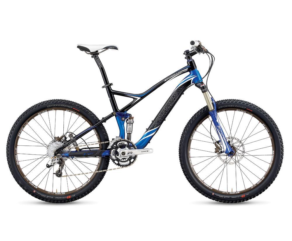 Specialized S-Works Stumpjumper FSR Carbon: A mountain bike featuring a sleek black frame with blue accents, equipped with thick tires, a dual suspension system, and Shimano XT gear components, positioned against a neutral background.