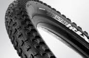 Bontrager XR4 Comp: Close-up view of a mountain bike tire, showcasing its textured tread pattern and sidewall.