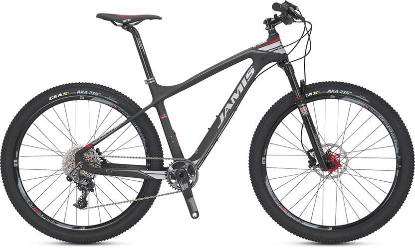 A lightweight mountain bike featuring a sleek black carbon frame, front suspension fork, and disc brakes. The bike includes knobby tires designed for off-road terrain, with visible gear components and handlebar controls. The brand "Jamis" is prominently displayed on the frame.
