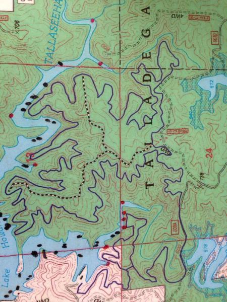Topographic map of the Talladega area, featuring contour lines and water bodies. The map includes labeled trails and points of interest, with areas shaded in various greens indicating elevation changes. Sylaward mountain bike trail.