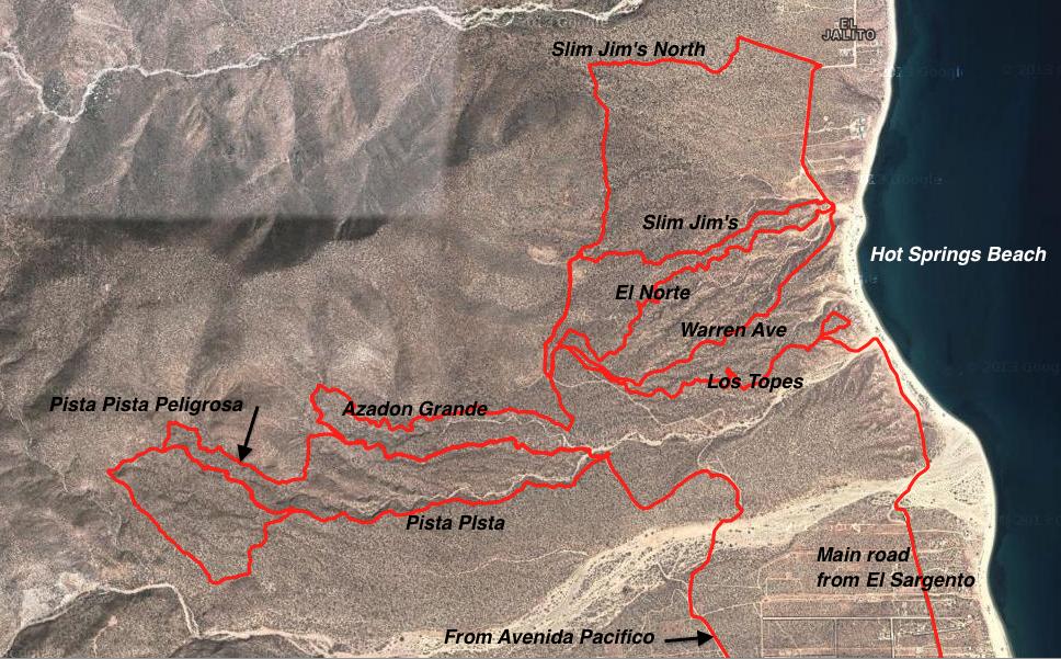 A detailed map showing various trails and routes around a coastal area, labeled with names such as "Slim Jim's North," "El Norte," "Warren Ave," and "Hot Springs Beach." The trails are outlined in red, with specific paths marked, including "Pista Pista Peligrosa" and "Azadon Grande." The surrounding terrain is mountainous with a beach visible along one edge of the map. Warren Ave mountain bike trail.