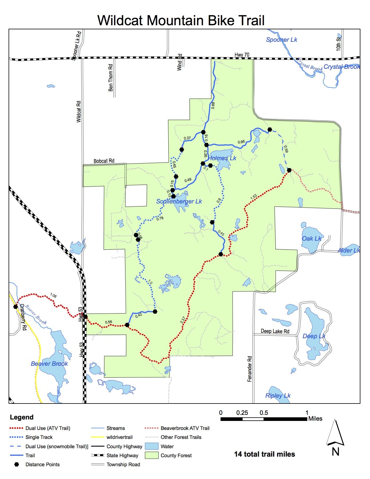 Map depicting the Wildcat Mountain Bike Trail, highlighting various trail types including dual use (ATV), single track, and forest trails. The map features landmarks such as lakes and streams, as well as distance points and surrounding roads. Total length of the trail is 14 miles. Wildcat Trail mountain bike trail.