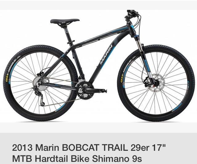 Marin Bobcat Trail: Alt text: 2013 Marin Bobcat Trail 29-inch hardtail mountain bike in black and blue, showcasing a lightweight frame, front suspension fork, and Shimano 9-speed gear system.
