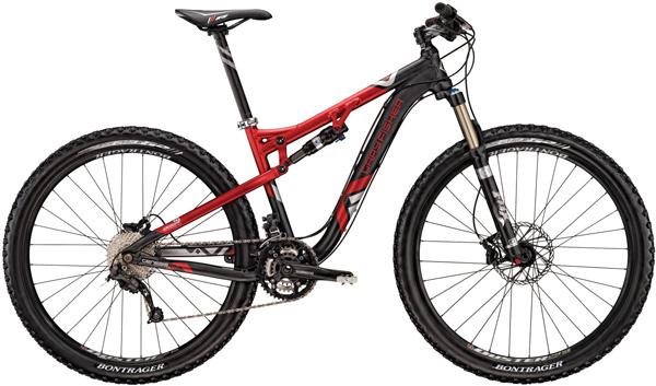 Gary Fisher Rumblefish: A red and black mountain bike with dual suspension, equipped with disc brakes and wide knobby tires, set against a plain background.