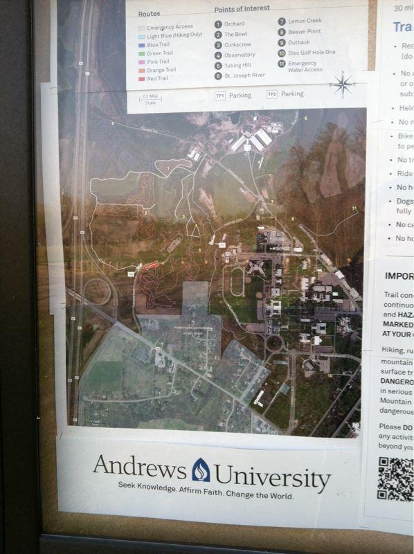 Map of Andrews University showing trails, routes, and points of interest such as parking areas, hiking trails, and recreational spots. The map includes a legend indicating different trail types and emergency access points. Andrew's University Trail mountain bike trail.