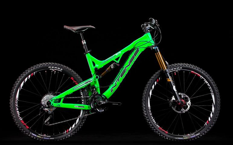 Intense Tracer 275: A brightly colored green mountain bike with black and silver components, set against a black background. The bike features large tires, suspension forks, and a sleek frame design, showcasing its suitability for off-road cycling.