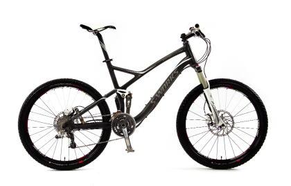 Specialized S-Works Stumpjumper FSR: A modern mountain bike with a sleek black and silver frame, featuring front and rear disc brakes, wide tires, and a lightweight design, positioned against a plain white background.